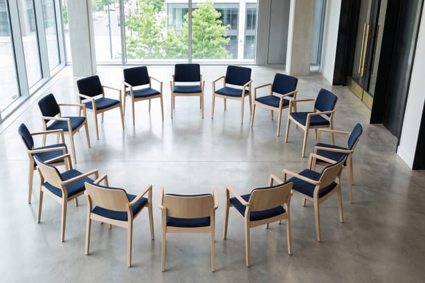 Chairs set in a circle for a facilitated conversation