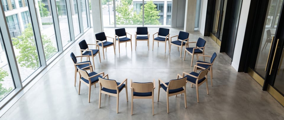 A single circle of chairs set for a facilitated conversation